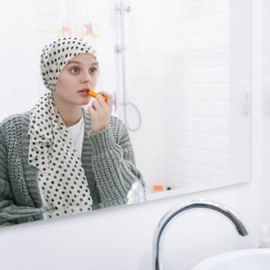 Woman in White and Black Hijab Sitting on White Bathtub